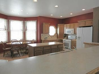 Oversized open kitchen with oak cabinets & granite countertops...plenty of eating space