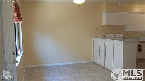 Lovely and large dining area just off of kitchen and living room!  Big window allowing tons of natural light into dining area & kitchen!  Newly painted, new floor coverings and direct access door to exterior side yard!  Note all of the extra storage in the dividing bar between kitchen & dining area!