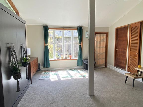 Entryway with Murphy bed closed looking towards backyard.