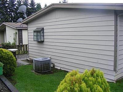 Back of home and Heat Pump.