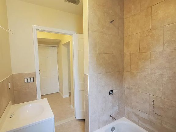 Bathroom contains plenty of storage shelves and a window for additional natural light.