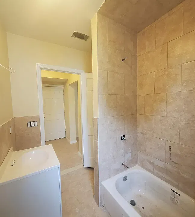 Bathroom contains plenty of storage shelves and a window for additional natural light.