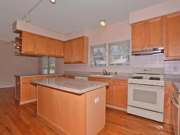 Open kitchen and breakfast room with granite counter tops, maple cabinets, walk-in pantry and two ov