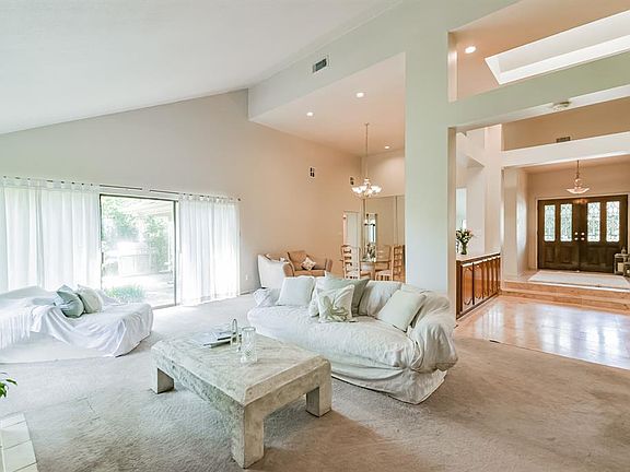 22x15 Family Room - Let your cares lift under a soaring vaulted ceiling. The skylight infuses a splash of sunshine for cheer. Add friends and family to the mix for joy.
