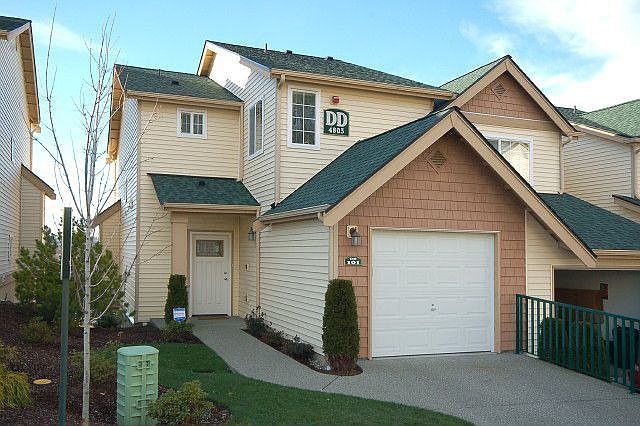 Attached garge, a deck, and a fenced yard