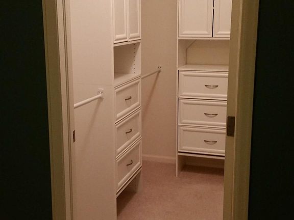 Large walk-in closet with custom built-ins.