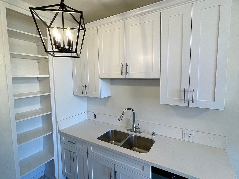 Remodeled kitchen with all stainless appliances and fixtures - dishwasher, range, microwave, refrigerator