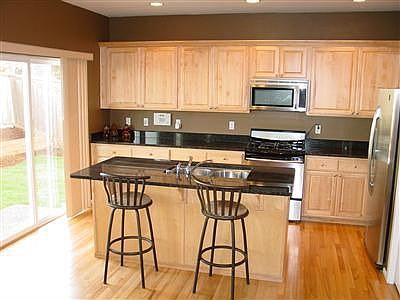 Amazing Kitchen with Slab Granite, Oak Hardwood, Stainless Steel Appliances.