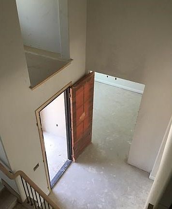 Great two-story foyer! Beautiful 8ft iron front door (orange is just to protect the door during construction).