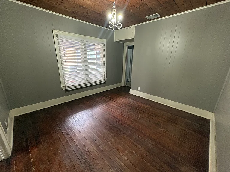 Past the living room is a separated room that can serve as a dining room or office.
