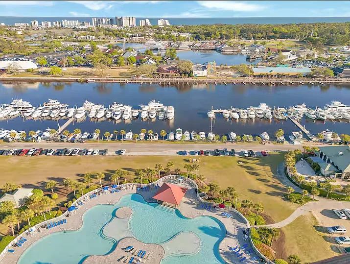 A view of Barefoot Landing across the Intercoastal Waterway & North Tower Pool (yes, you have access!). Park in the dirt parking lot to the right (in front of Marina Bar & Grill).