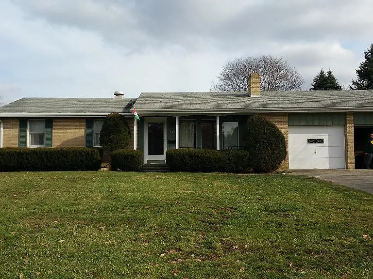 Front of house showing double wide driveway and two car garage.