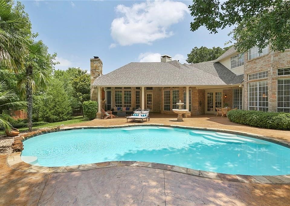 YOUR VERY OWN BACKYARD PARADISE WHERE LUSH LANDSCAPING SURROUNDS THE BEAUTIFUL POOL & PATIO WITH A GORGEOUS STONE FIREPLACE!