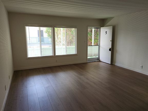 Spacious Livingroom with large windows and laminate floors