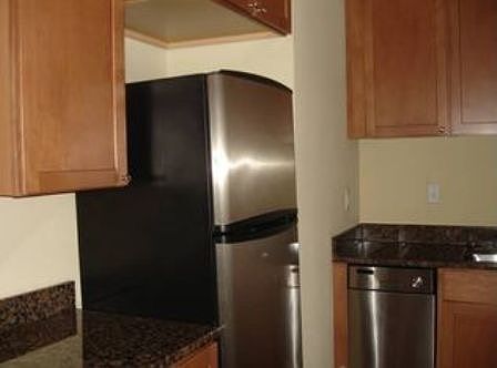The kitchen offers granite countertops, stainless steel appl