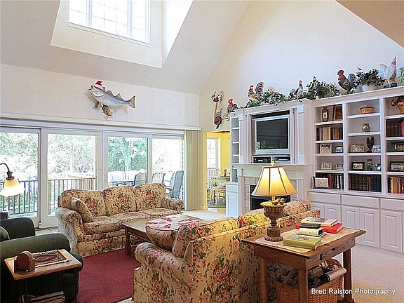 Great room with fireplace & Anderson window wall opening to deck. The fish mounted on the wall was caught very close to property