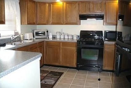 Kitchen : Open spacious design, tile floor, new Whirlpool appliances, recessed lighting.