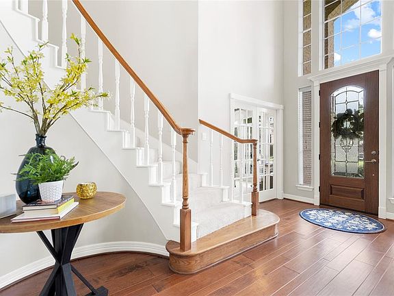 View of the foyer and front door and circular staircase.