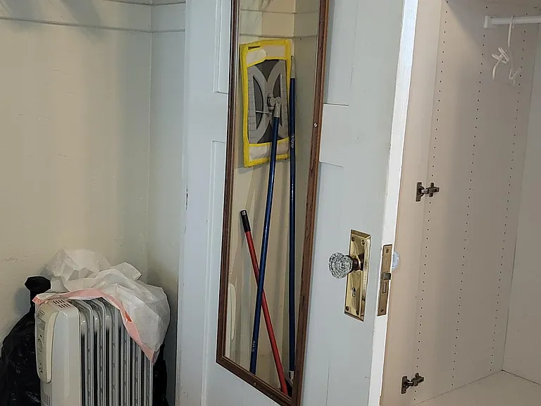 Oil filled radiant heater can supplement the new a/c heat window unit on those rare cold days in Dec and Jan. Vacuum can be stored here too since still plenty of space for other things in the other two wardrobes in the bedroom.