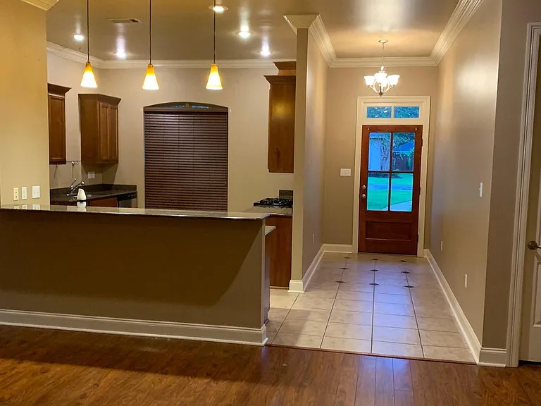 View of kitchen from living room! Open floor plan which gives view of living room with fireplace and built in wine area.