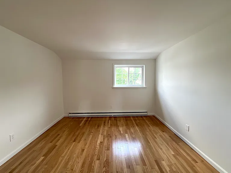 Bedroom with hardwood floors, natural lighting and closet