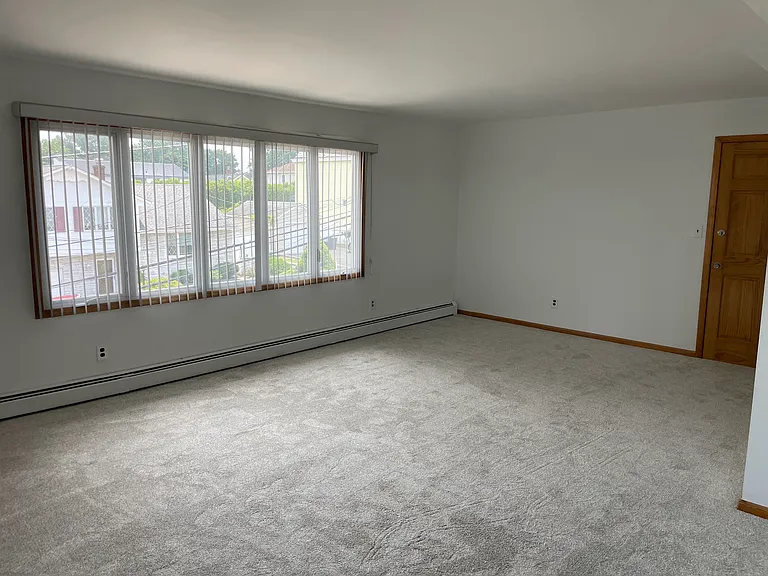 Living room with 2nd entry into apartment.