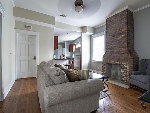 living room , door to far left is to small bedroom, closed door to back bedroom with private bath.