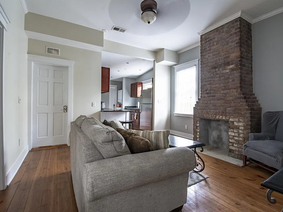 living room , door to far left is to small bedroom, closed door to back bedroom with private bath.