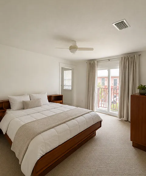 Upstairs primary bedroom with private full bath and balconey. Sunlight from sliding glass door facing north and window facing south make this room a perfect retreat.