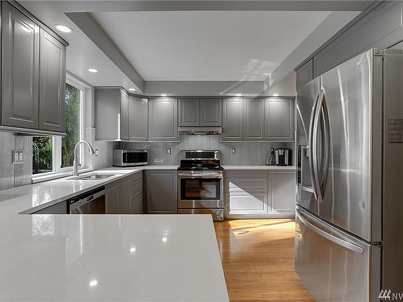 Modern kitchen with brand new cabinets, quartz countertops, stainless appliances and new hardwoods.