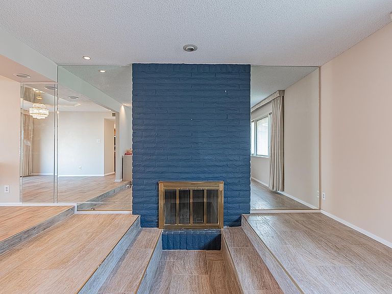 Sunken living room with brick fireplace