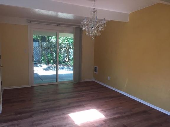 Dining room with sliding glass door to patio. Nice chandler.