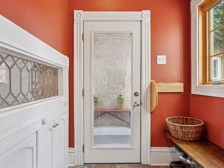Shared entryway, where tenants can retrieve mail as well. Entryway leads right out to both garages, as well as the back patio and backyard. Full yard is gated off for added privacy, with a TALL privacy fence in the backyard. No peaky neighbors.
