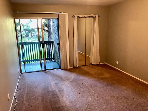 Master bedroom with walk-in closet and door to balcony