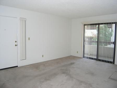 Living Room w/ Sliding Glass Door leads to Private Balcony