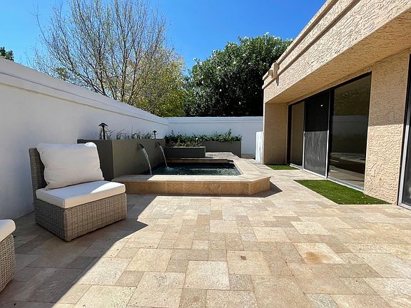 Private patio with spool and grass area for puppy.