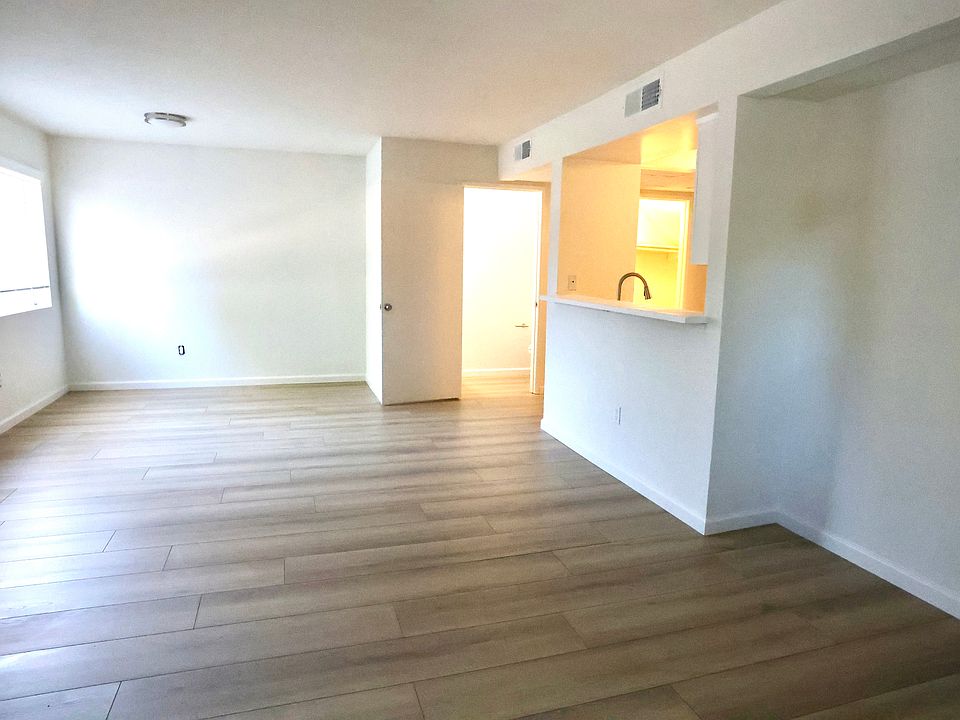 Balcony View into Living room with half bathroom and kitchen upper right of frame