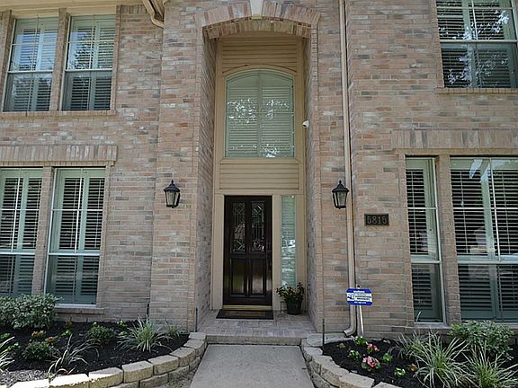 High arched front doorway inviting you inside.