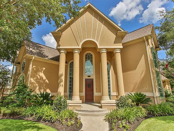 Mature trees and shrubs frame the fabulous entryway.