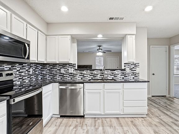 Kitchen with room for dining table. Refrigerator will stay.