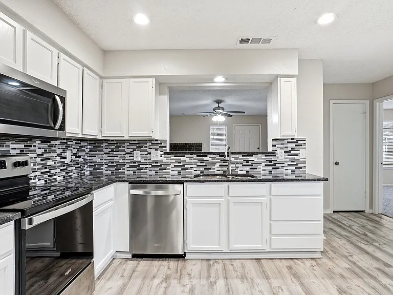 Kitchen with room for dining table. Refrigerator will stay.