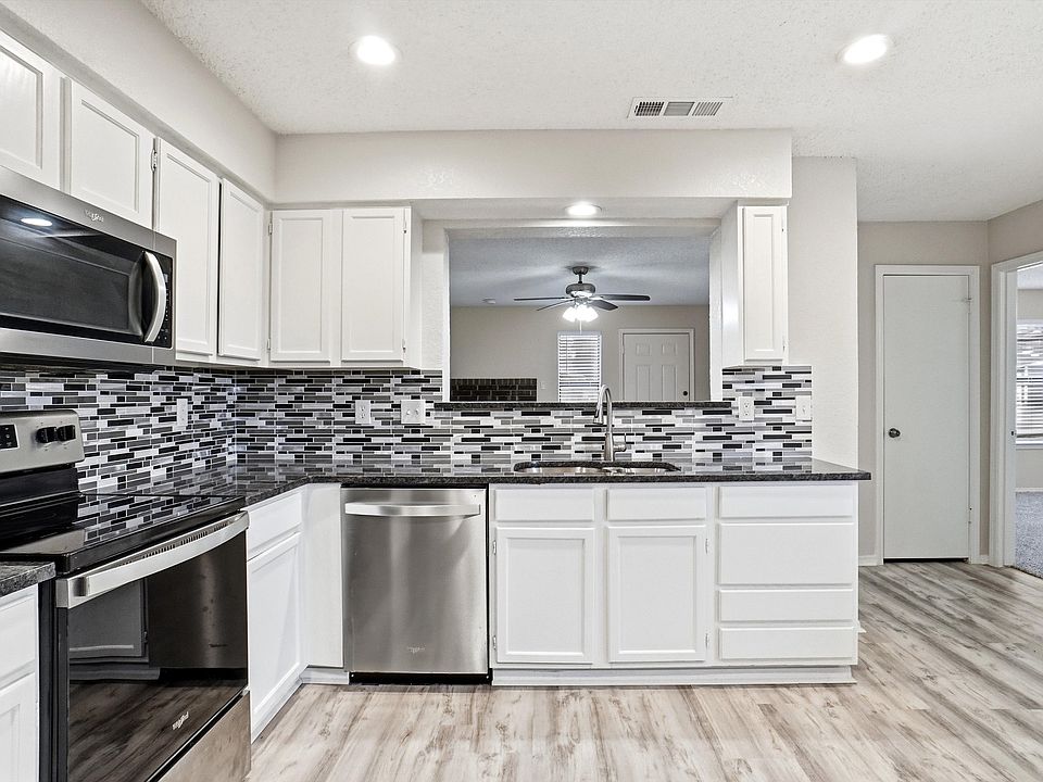Kitchen with room for dining table. Refrigerator will stay.