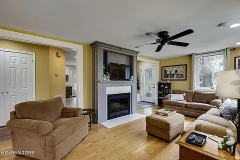 Living room with wood burning fireplace.