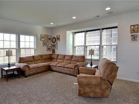 A great gathering place is the wonderful living room boasting neutral carpeting and premium surround sound.