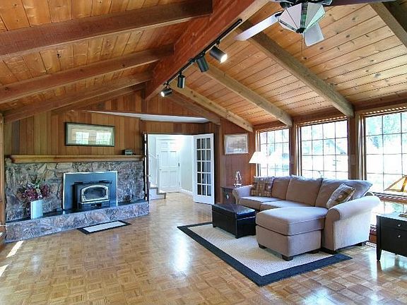 Family room with wet bar and wood buring Lopi stove spans a seasonal creek