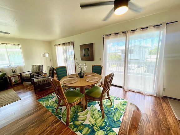 This photo shows the dining space towards the lanai and living area.