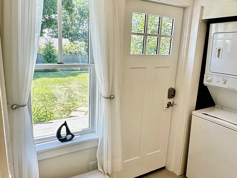 Mudroom entrance with onsite washer/dryer.