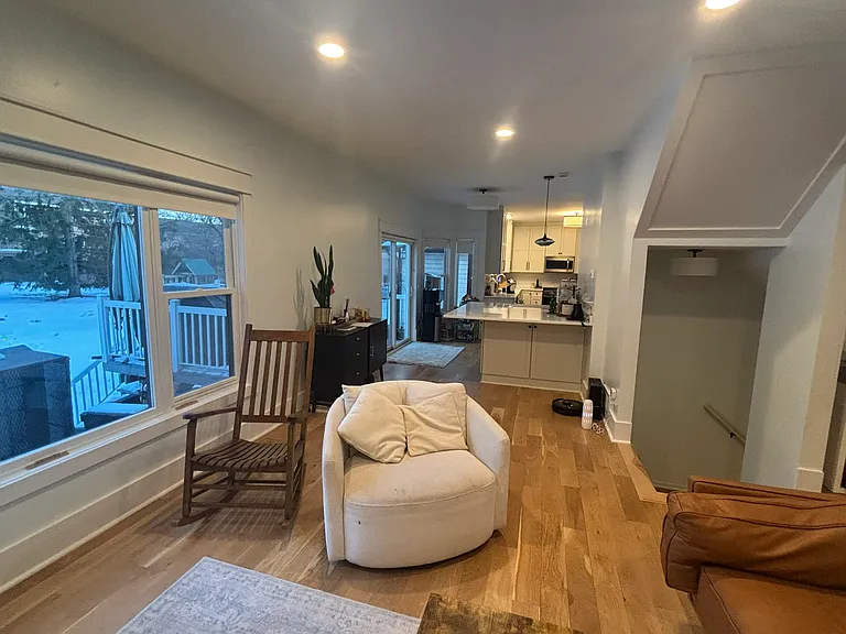 Living space with kitchen island in background.