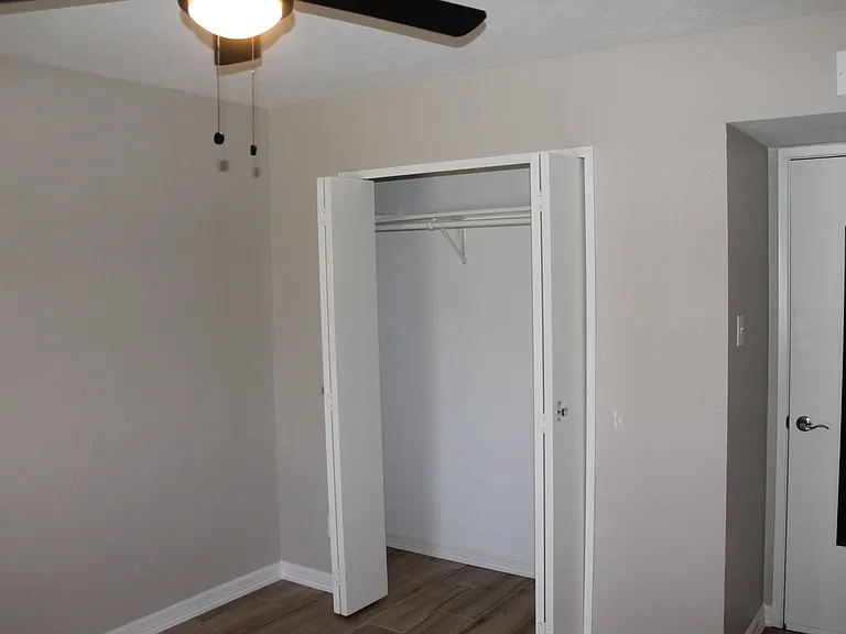 Bedroom #3 with closet storage and a new ceiling fan