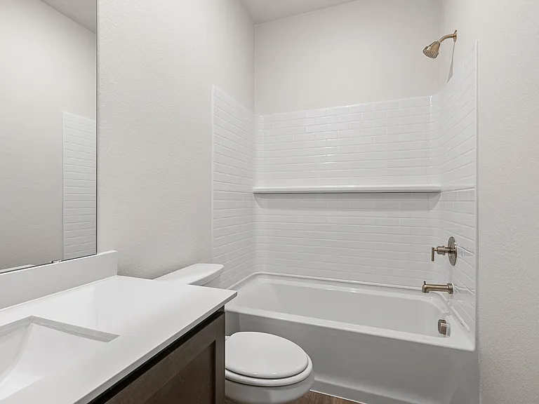 The secondary bathroom has a shower-tub combo.